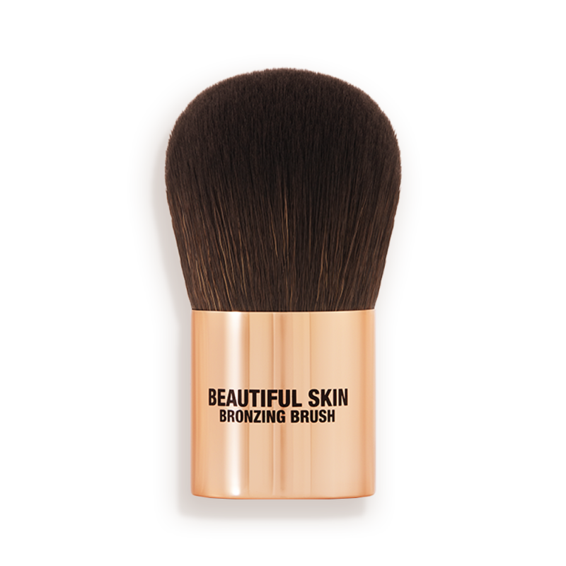 A bronzer brush with soft, dark brown synthetic bristles and a golden-coloured handle, perfect for both cream and powder bronzers.