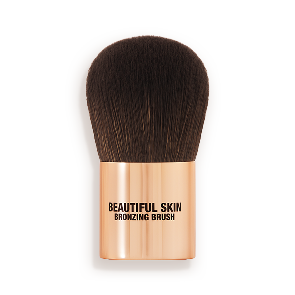 011_210558_BEAUTIFUL_SKIN_BRONZER_P_BS_BRONZER_BRUSH_RJ_2203__1_ A bronzer brush with soft, dark brown synthetic bristles and a golden-coloured handle, perfect for both cream and powder bronzers.