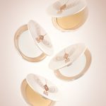 A collection of open, setting powder compacts in two shades, fair to light and medium to deep, in white and gold-coloured packaging.