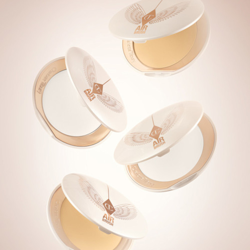 A collection of open, setting powder compacts in two shades, fair to light and medium to deep, in white and gold-coloured packaging.