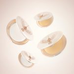 A collection of open, setting powder compacts in two shades, fair to light and medium to deep, in white and gold-coloured packaging.
