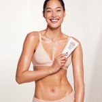 Fair skin model wearing and holding Magic Body Cream