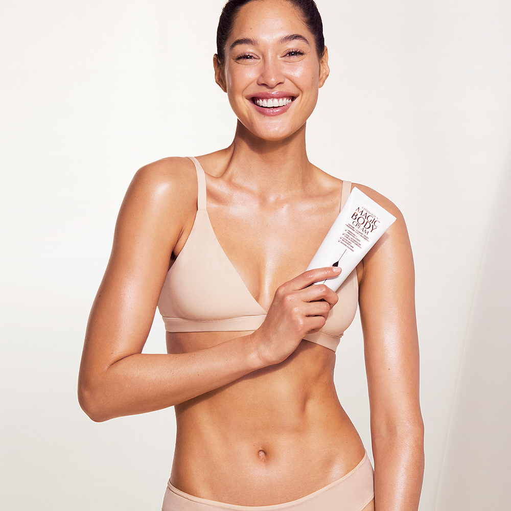 Fair skin model wearing and holding Magic Body Cream