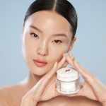 Fair skin tone model holding Magic Water Cream