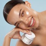 Aliana applying Charlotte's Magic Water Cream gel moisturiser to the cheek