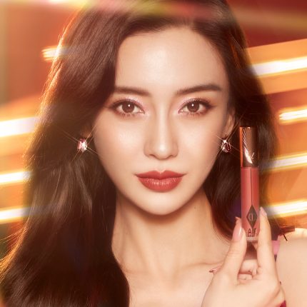 Model holding Airbrush Lip Blur