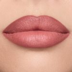 Close-up of a model's lips shaded a warm berry-pink.