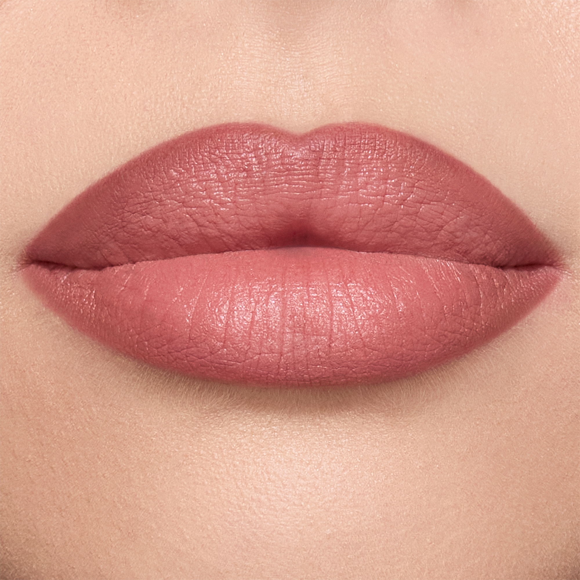Close-up of a model's lips shaded a warm berry-pink.