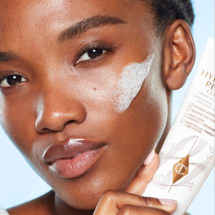 Mae applying Charlotte's Magic Hydration Revival Cleanser in their skincare routine for oily skin