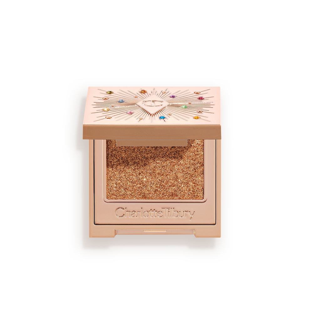 20240404_CT_HOLIDAY_S12_POP_SHOT_0159_SUNLIT_DIAMOND An open, single-pan eyeshadow with a mirrored lid in an iridescent orange-gold shade with very fine shimmer.