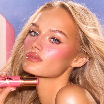 Medium model holding and wearing Pink blush shade.