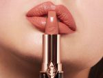 Lips close-up of a light-tone model wearing a nude-pink, universally-flattering lipstick.