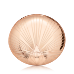 A closed, pressed powder compact in golden, metallic packaging with a starburst pattern on the lid.