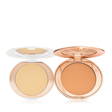 Two, open, setting powder compacts with mirrored-lids and white and gold-coloured packaging, in banana yellow and clay-brown shades.
