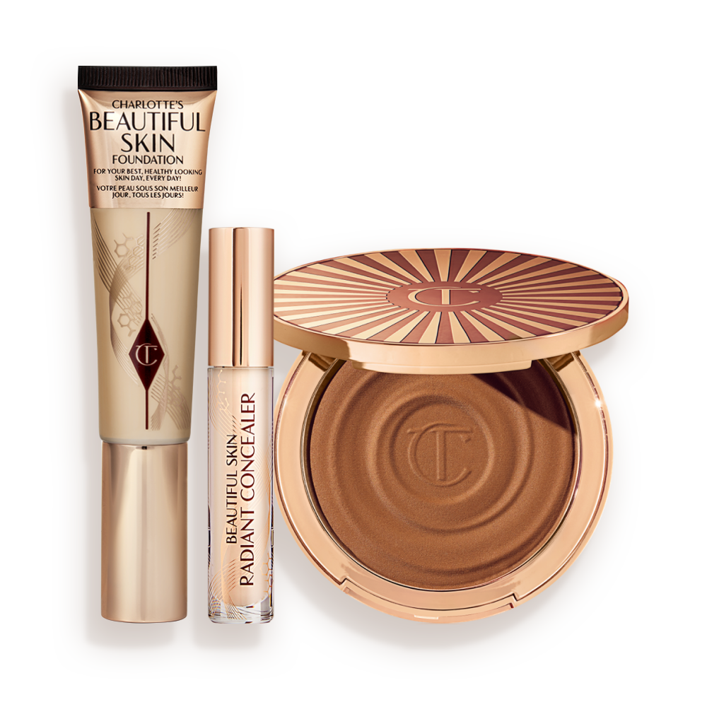 BEAUTIFUL_SKIN_3-STEP_ROUTINE-BUNDLE Foundation in a sleek gold-coloured tube with a concealer in a glass tube and gold-coloured lid, and dark brown cream bronzer compact in gold-coloured packaging.