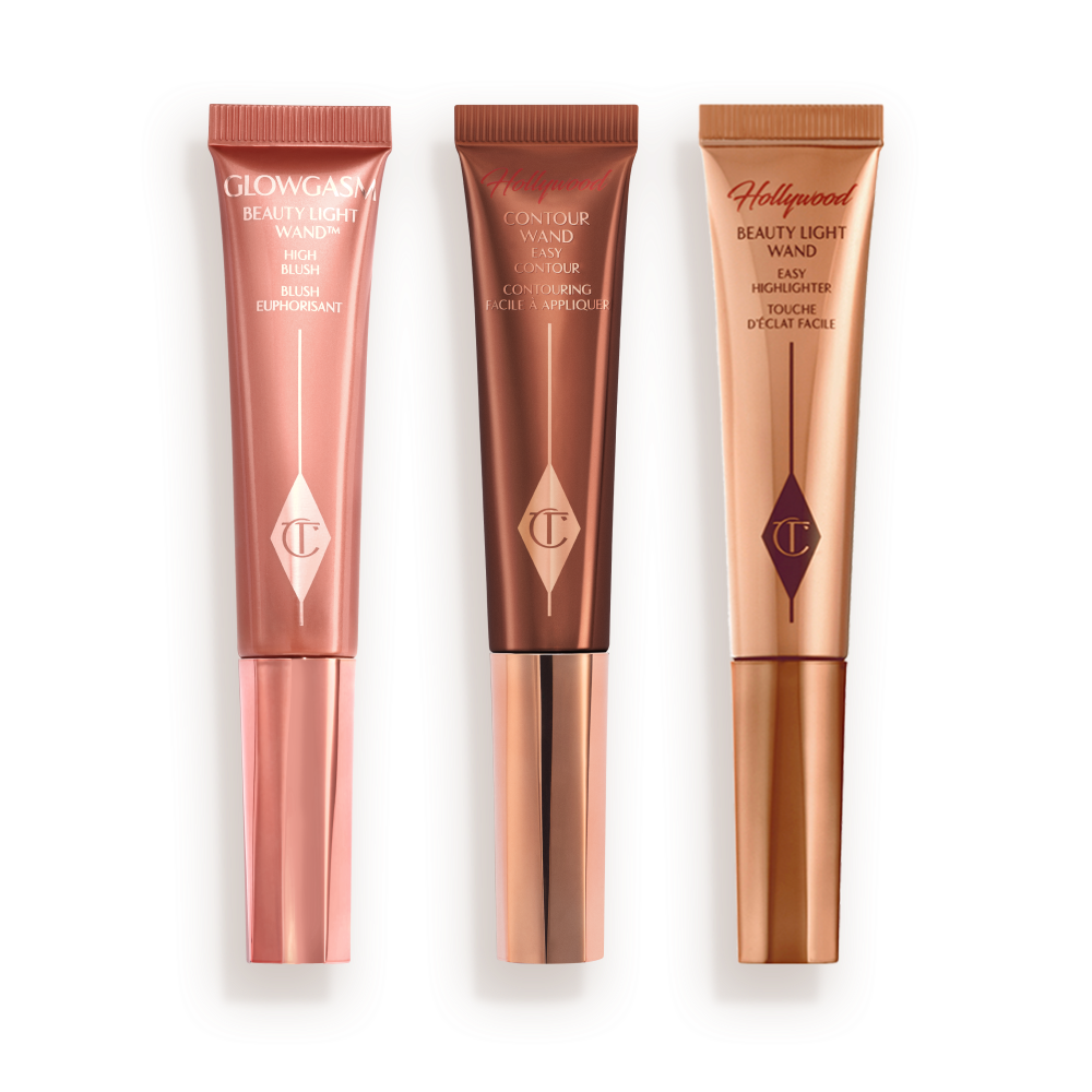 BELIWAHCOKIT_-_BEAUTY_LIGHT_WAND___HOLLYWOOD_CONTOUR_KIT Medium-pink liquid blush wand, glowy brown contour wand, and soft candlelight-gold-coloured liquid highlighter wand.