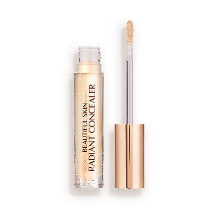 Light beige radiant concealer in a glass tube with its gold-coloured lid with a doe-foot end next to it, and text on the tube that reads, 'Beautiful Skin Concealer'