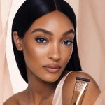 Jordon Dunn wearing Beautiful Skin Foundation and holding the Beautiful Skin Foundation packaging