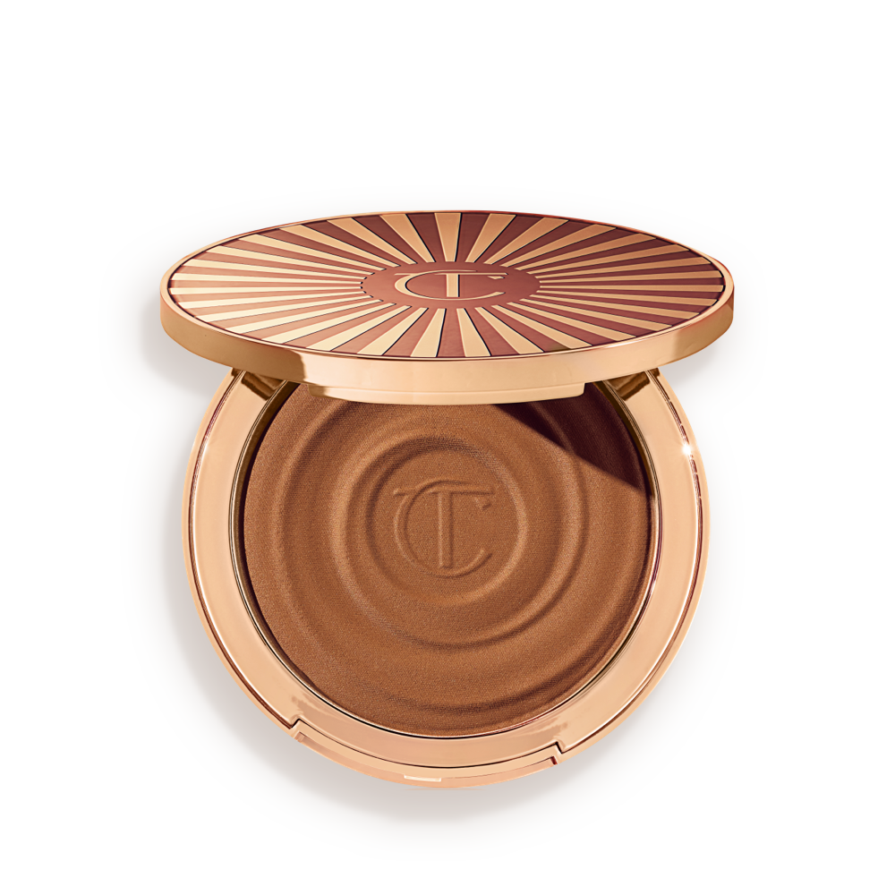 Beautiful-Skin-Bronzer-Medium-Packshot Open, cream bronzer compact in a medium-brown shade with gold-coloured packaging.