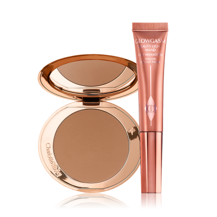 An open, mirrored-lid bonzer compact with a warm-brown bronzer and a highlighter-blush wand in a warm pink shade.