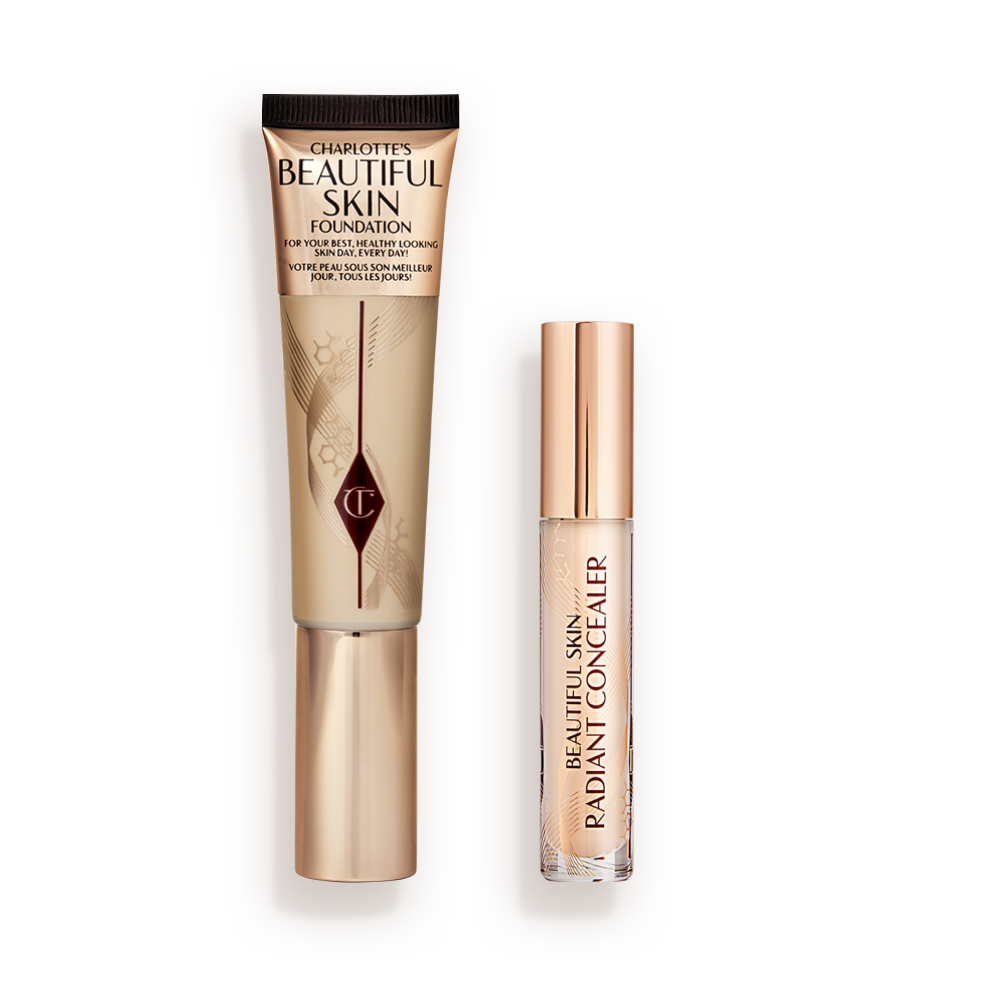 CHARLOTTEa__S_BEAUTIFUL_SKIN_COMPLEXION_KIT Foundation in a sleek gold-coloured tube with a concealer in a glass tube and gold-coloured lid.