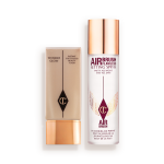 Foundation in a rectangular, clear bottle with a gold-coloured lid and setting spray in a large, clear bottle with a gold-coloured lid.