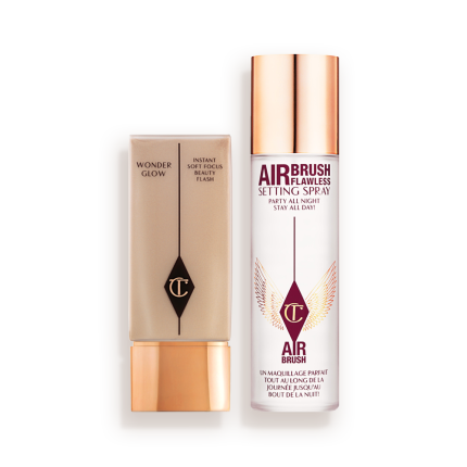 Foundation in a rectangular, clear bottle with a gold-coloured lid and setting spray in a large, clear bottle with a gold-coloured lid.