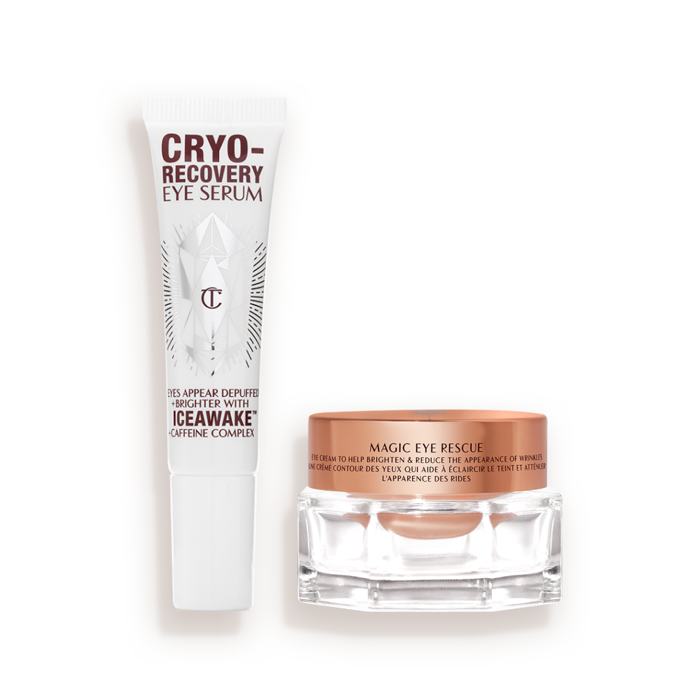 CHARLOTTEa__S_RESEARCH-POWERED_EYE_DUO-BUNDLE An open, white-coloured eye serum tube with silver-colour geometric patterns on the front and text written on it that reads, 'eye appear depuffed and brighter with Iceawake, caffeine complex' and an open, champagne-coloured thick, eye cream in a glass pot with a gold-coloured lid.