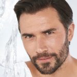 A fair-tone, brunette, male model with flawless, smooth, clear glass skin.