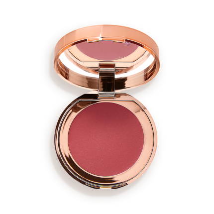 An open, mirrored-lid lip and cheek cream compact in a warm rosebud-pink shade.