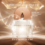 A luxurious open jar of cream with a glowing, golden background. The product lid, featuring the Charlotte Tilbury logo, hangs above the jar as a swirl of cream peaks from the top. Text on the image highlights the ‘New! Supercharged Formula’ with a ‘world‑first Recoverstem Peptide,’ and a claim that 4 out of 5 users agree it feels like ‘a facelift in a jar.