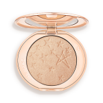 An open highlighter powder compact with a mirrored lid, in a shimmery champagne shade.