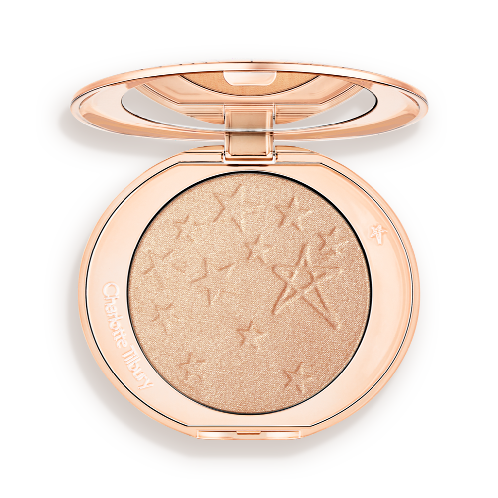 Hollywood-Highlighter-Champagne-Glow-Packshots An open highlighter powder compact with a mirrored lid, in a shimmery champagne shade.