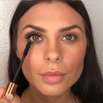 A medium-tone model with brown eyes with jet-black, volumising mascara on one eye and no mascara on the other.