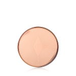 A closed lip and cheek cream product compact with rose gold packaging and a starburst pattern on the lid.