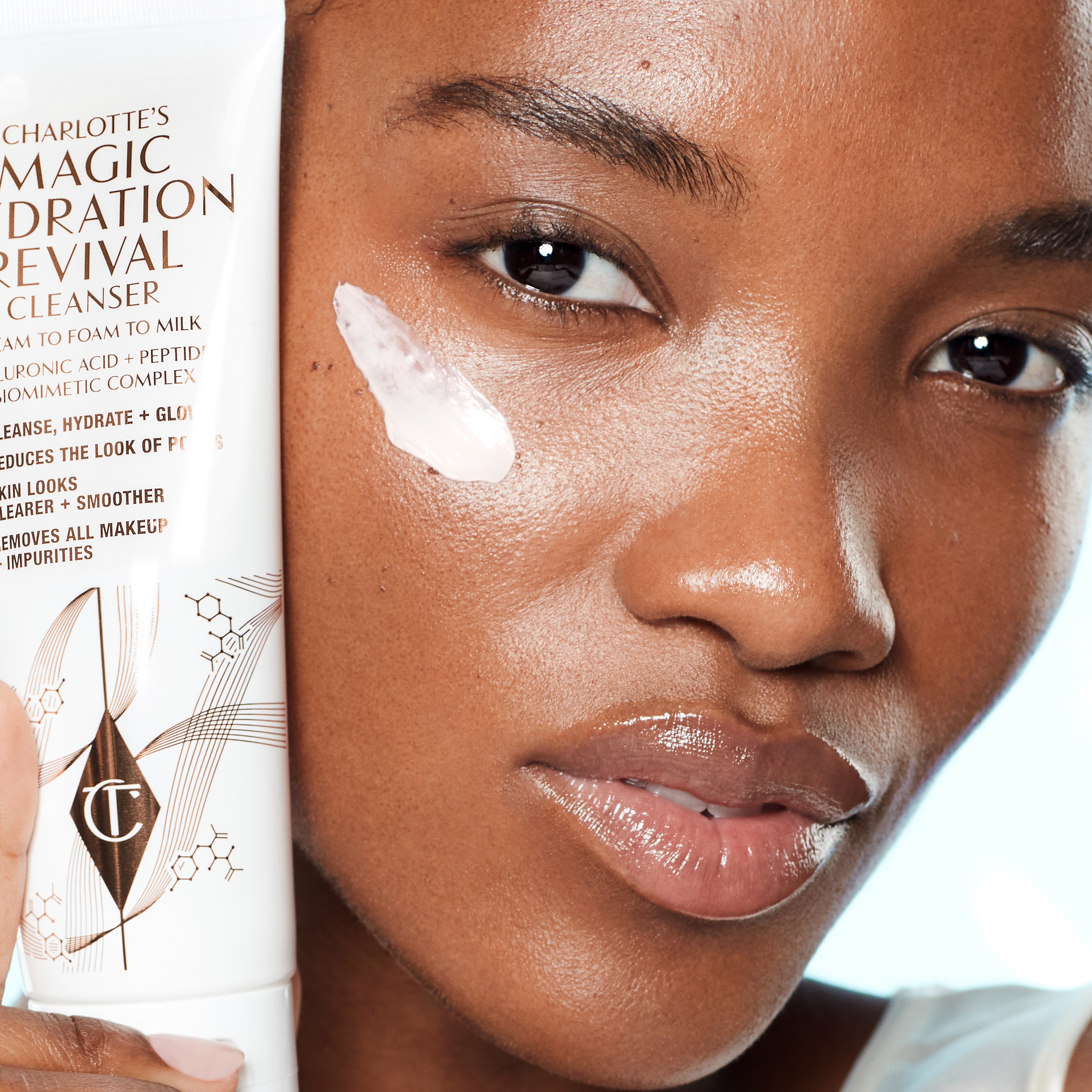 Model applying Charlotte's Magic Hydration Revival Cleanser