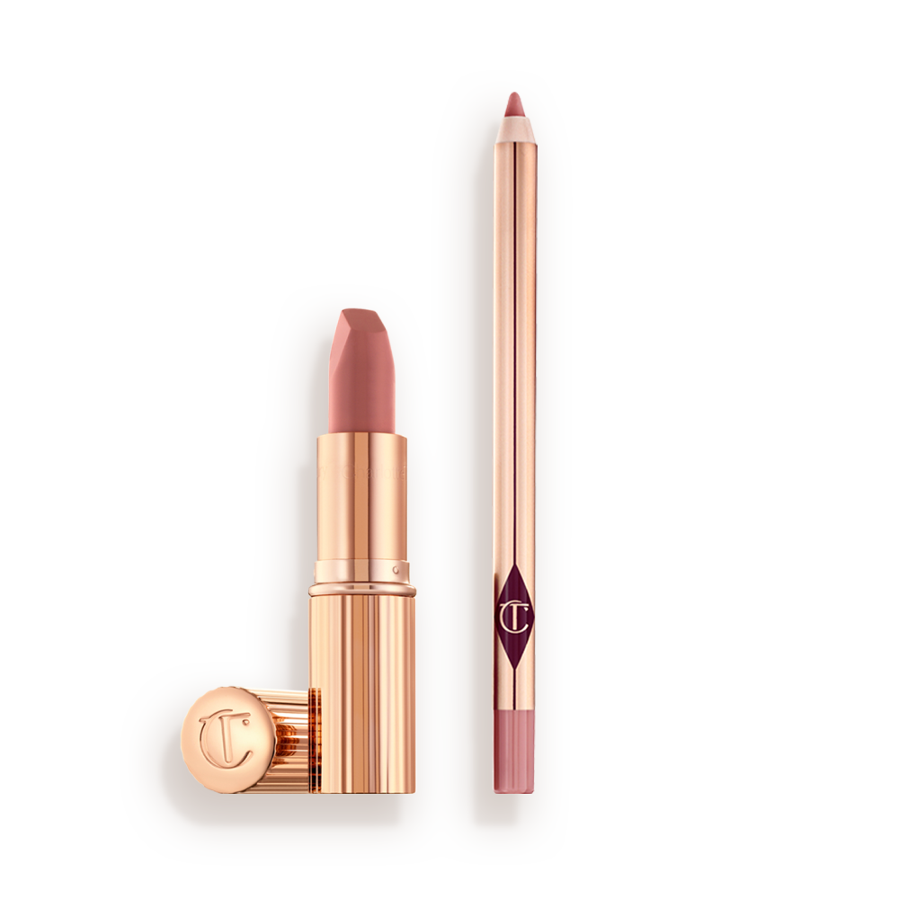 PILLOW_TALK_LIP_KIT-BUNDLE An open nude pink lipstick in a gold-coloured tube and lip liner pencil in a nude pink shade.