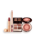 A makeup kit containing a two-tone pink and rose gold blush, a berry and pink quad eyeshadow palette, a nude-pink lip liner pencil, and rose-pink lipstick.