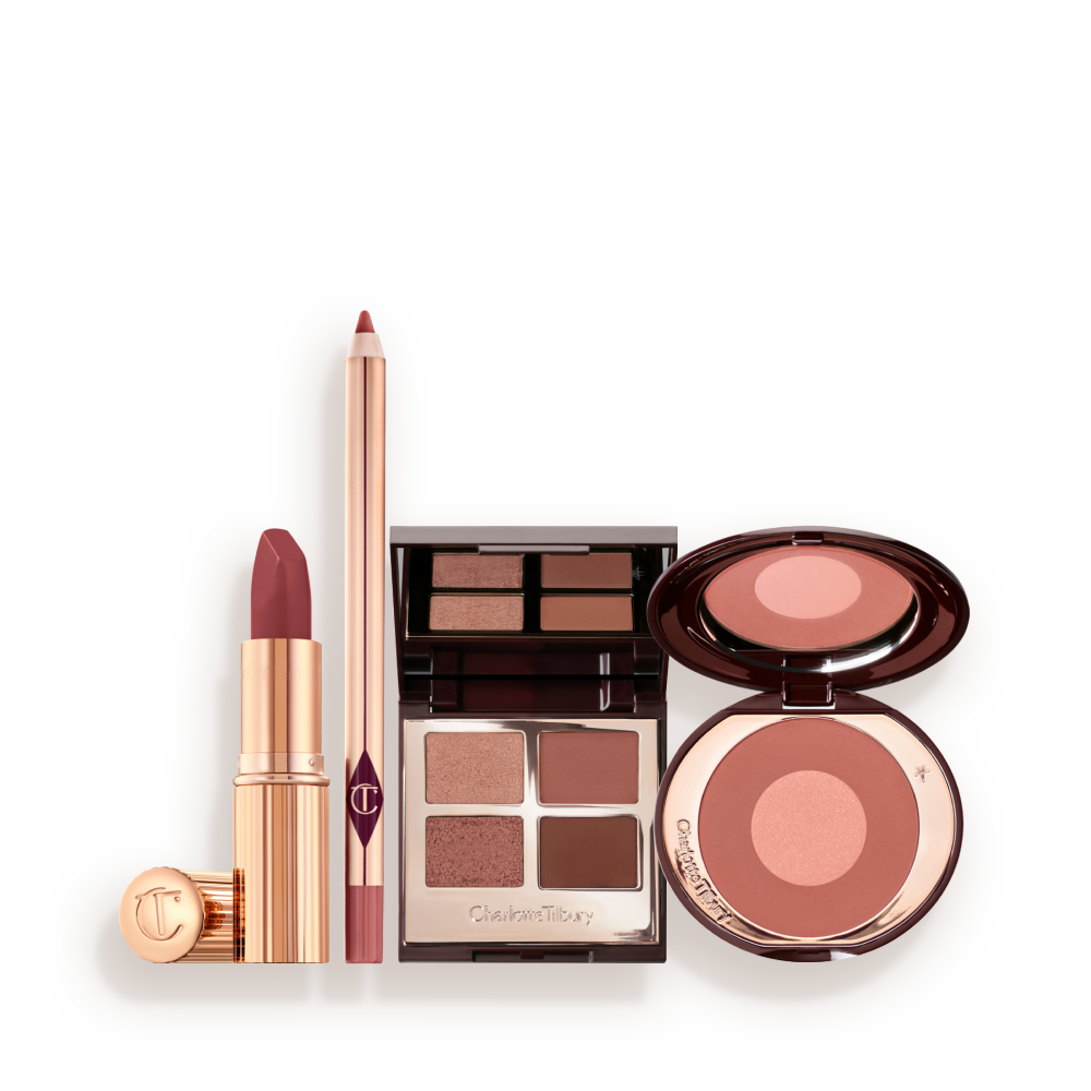 PILLOW_TALK_MAKEUP_SECRETS_MAKEUP_KIT A makeup kit containing a two-tone pink and rose gold blush, a berry and pink quad eyeshadow palette, a nude-pink lip liner pencil, and rose-pink lipstick.