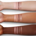 Arm swatches of a quad eyeshadow palette with light pink, dark pink, dark brown, and light brown eyeshadow.