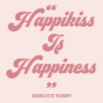 Peach-coloured wallpaper that reads, 'Happikiss is Happiness'.