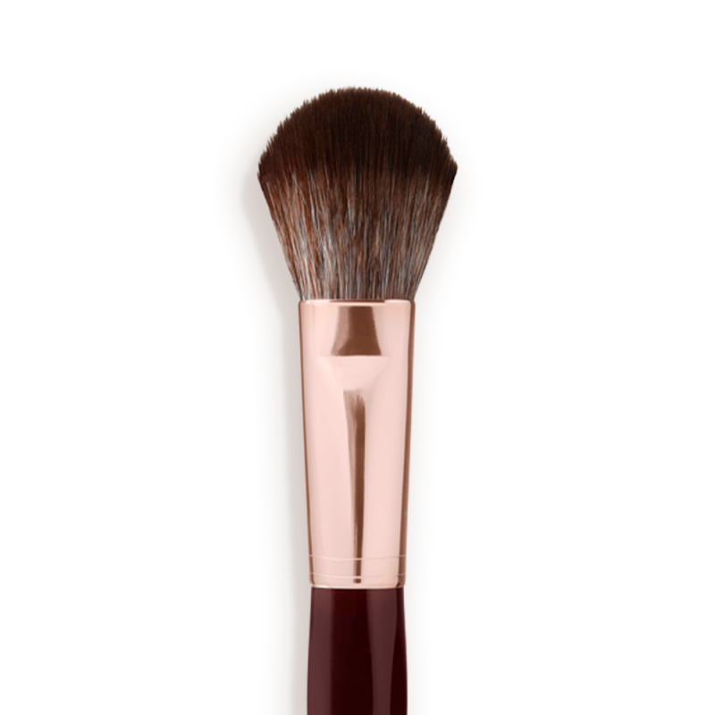 Close-up of a bronzer and blush brush with dark brown and grey bristles with a rose-gold and dark crimson handle.