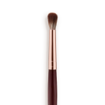 Close-up of an eyeshadow blending brush with soft bristles and a rose-gold and dark crimson handle.