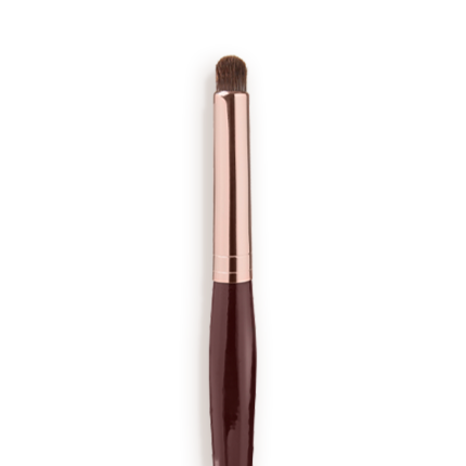 Close-up of an eyeshadow smudging brush with soft bristles and a rose-gold and dark crimson handle.