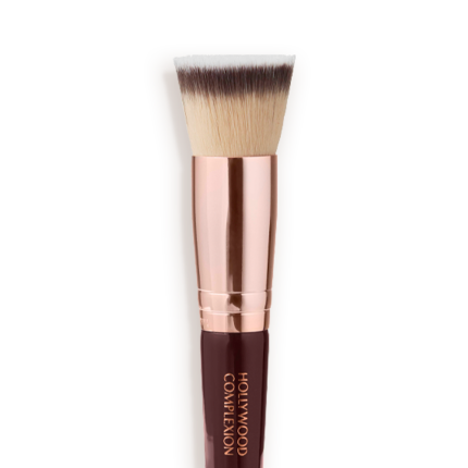 Close-up of a face blending contour brush with fawn, dark brown, and white-coloured bristles with rose-gold and dark crimson handle.