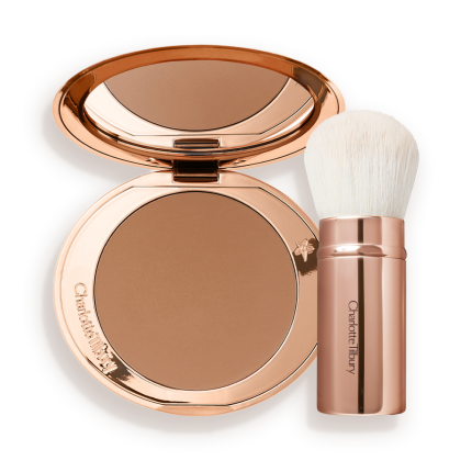 An open bronzer compact in a light brown shade and a kabuki brush with white-coloured bristles and a gold-coloured handle.