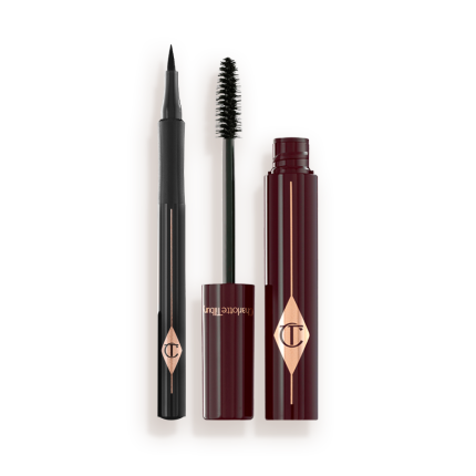 An open mascara with its applicator next to it in dark crimson-cloured packaging and an open eyeliner pen in black colour.