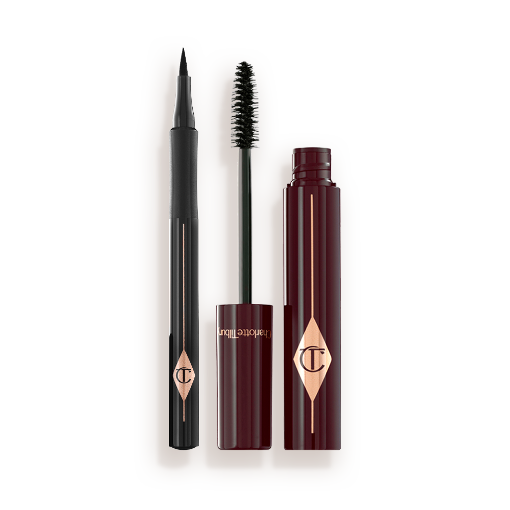 THE_FELINE_FLICK_KIT An open mascara with its applicator next to it in dark crimson-cloured packaging and an open eyeliner pen in black colour.