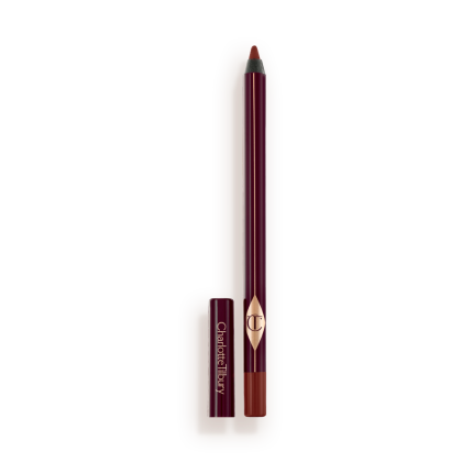 An eyeliner pencil in a berry-pink shade with its lid next to it.