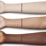 Swatch of an eyeliner in a berry-pink shade on fair, tan, and deep-tone arms.